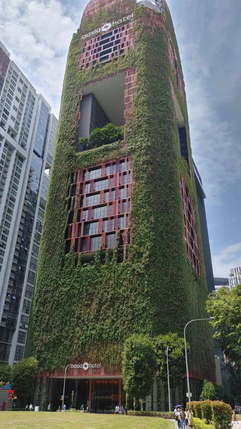 Oasia Hotel tower that is totally covered in plants all up the walls